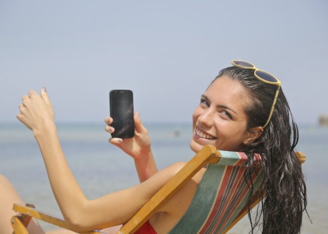 Woman Sitting On Sun Lounger