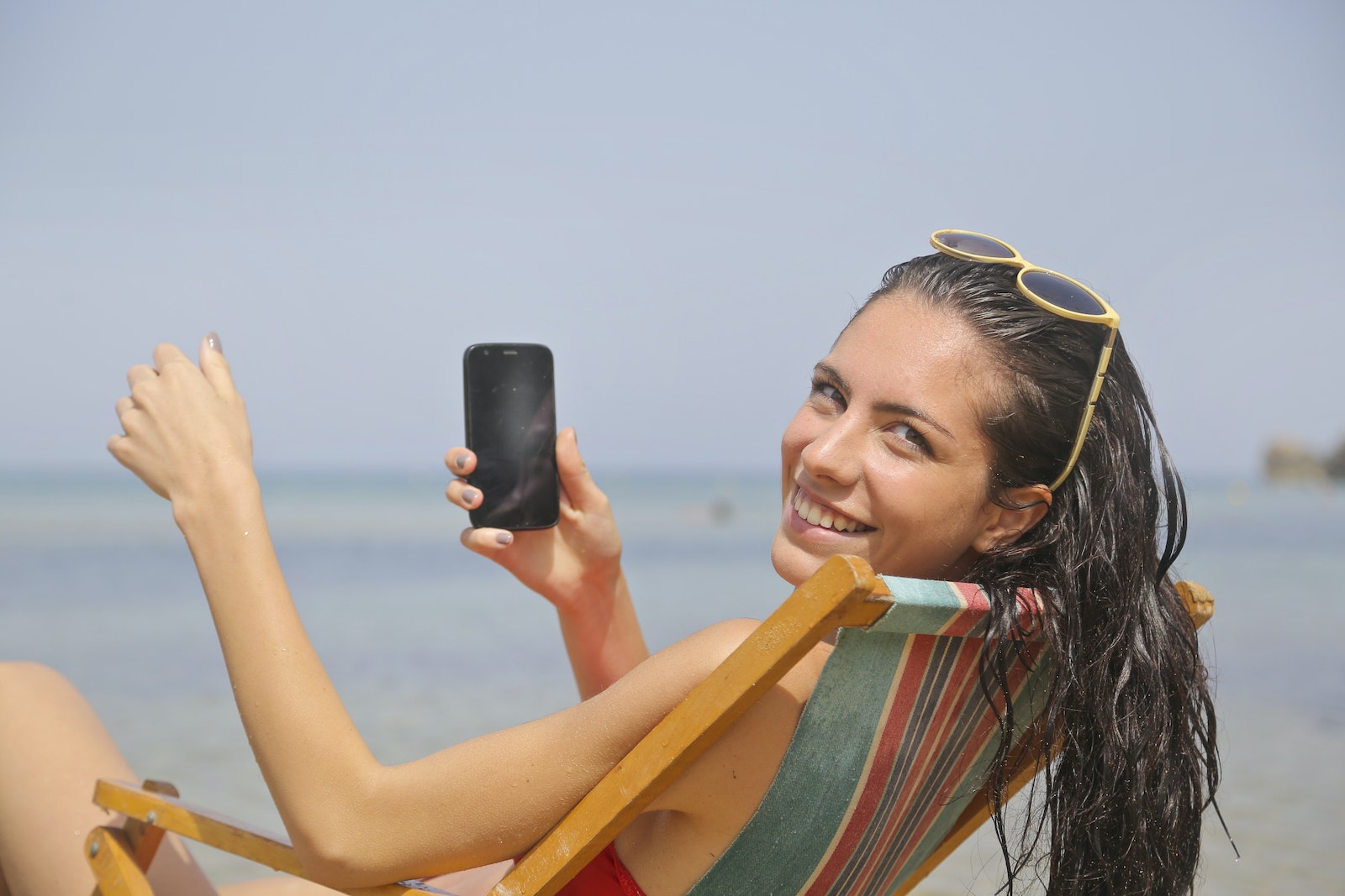 Woman Sitting On Sun Lounger