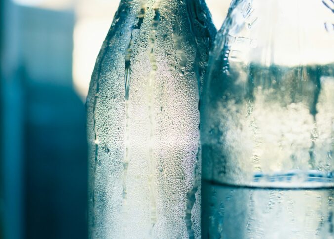 clear glass bottle with water